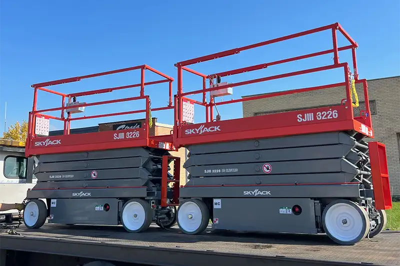Multiple red Skyjack SJIII3226 refurbished electric scissor lifts side by side